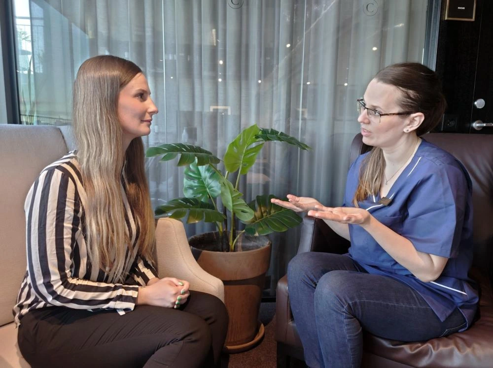 Dr Sandra Eriksson Mirkovic diagnosing palmar hyperhidrosis in a patient