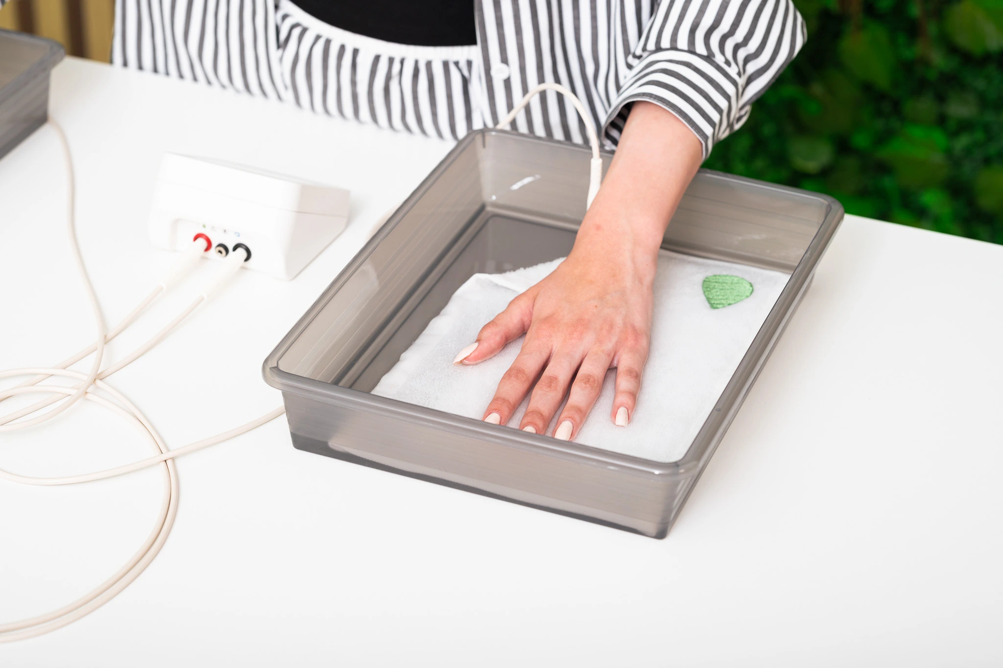 Patient using Hidroxa iontophoresis machine for excessive sweating hands